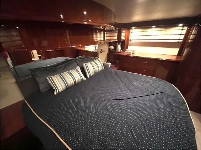 Slide: The Image of Luxurious bedroom interior of a 2004 Marquis 59 yacht with elegant wood finishes. - 15