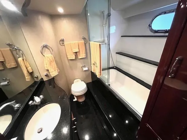 Slide: The Image of Luxurious bathroom in 2004 Marquis 59 yacht with sleek black countertops and modern fixtures. - 17