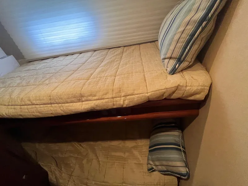 Slide: The Image of Bunk beds with striped pillows in a 2004 Marquis 59 interior. - 21