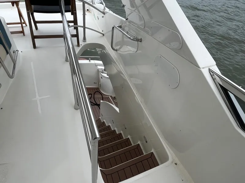 Slide: The Image of Staircase on 2004 Marquis 59 yacht, leading to lower deck with wooden steps. - 23