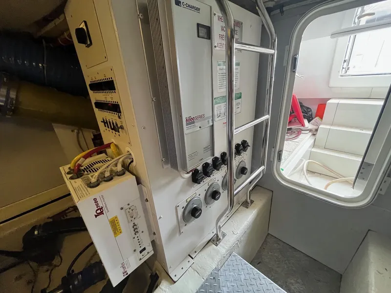 Slide: The Image of Electrical panel inside a 2004 Marquis 59 yacht, featuring control switches and wiring. - 31