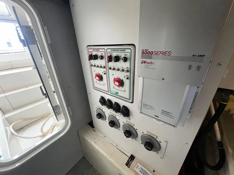 Slide: The Image of Electrical control panel inside a 2004 Marquis 59 yacht, featuring various switches and dials. - 32