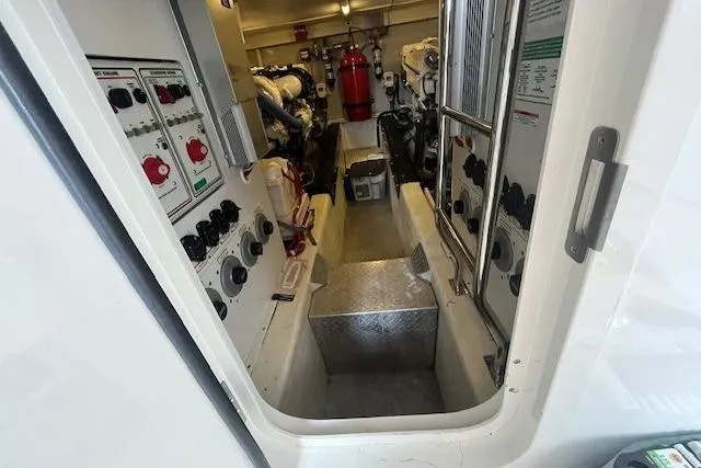 Slide: The Image of Engine room of a 2004 Marquis 59 yacht with control panels and equipment. - 37