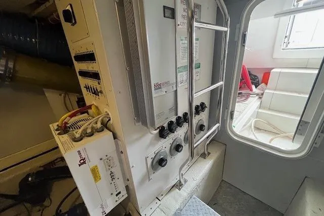 Slide: The Image of Engine room of a 2004 Marquis 59 yacht with control panels and equipment. - 40