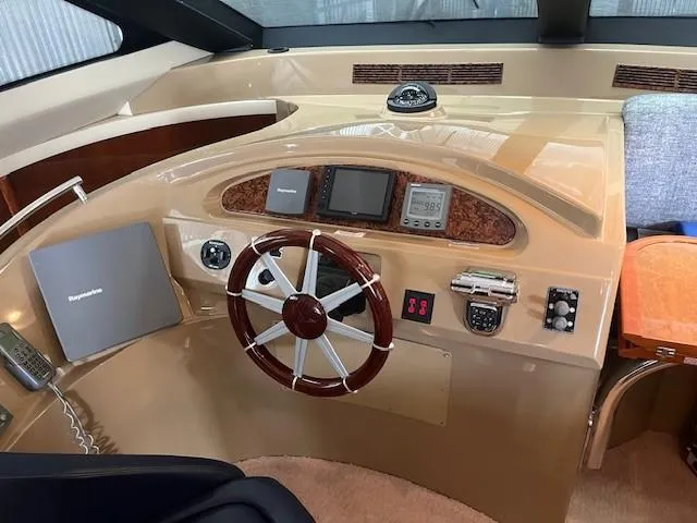 Slide: The Image of 2004 Marquis 59 yacht helm with steering wheel, navigation instruments, and control panel. - 6