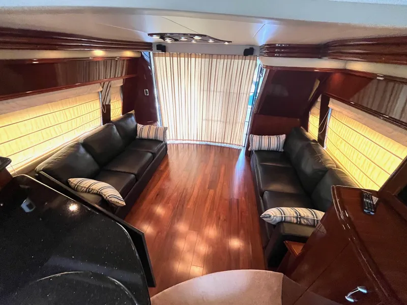 Slide: The Image of Luxurious interior of a 2004 Marquis 59 yacht with leather seating and wooden flooring. - 7