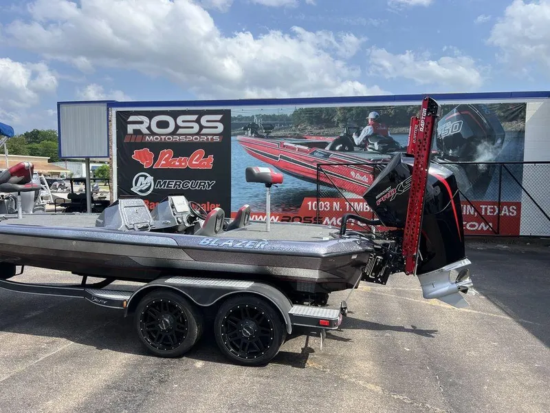 Slide: The Image of 2022 Blazer 650 Pro Tour boat at Ross Motorsports dealership under a cloudy sky. - 15