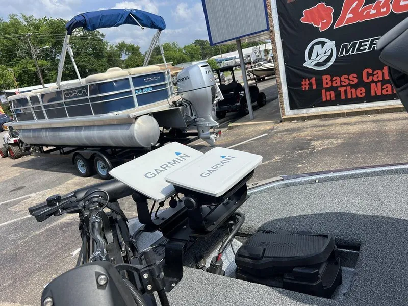 Slide: The Image of 2022 Blazer 650 Pro Tour boat with Garmin equipment, parked near a pontoon boat. - 23