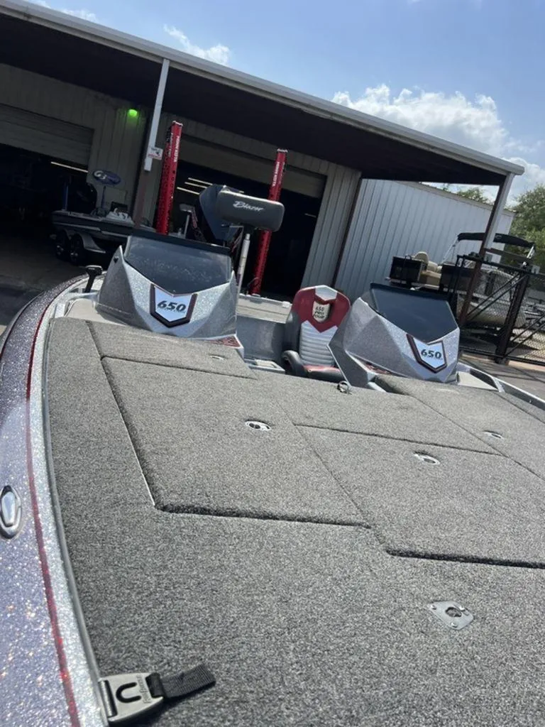 Slide: The Image of 2022 Blazer 650 Pro Tour boat with dual consoles, parked outside a garage. - 35