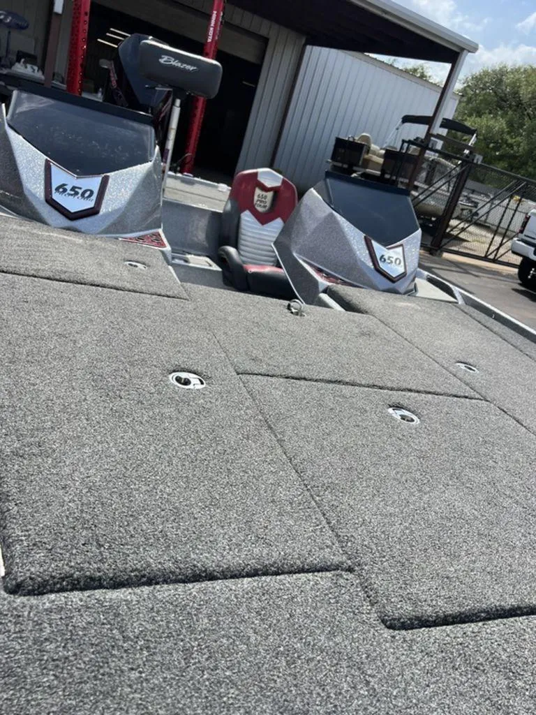 Slide: The Image of 2022 Blazer 650 Pro Tour boat with carpeted deck and dual consoles. - 36