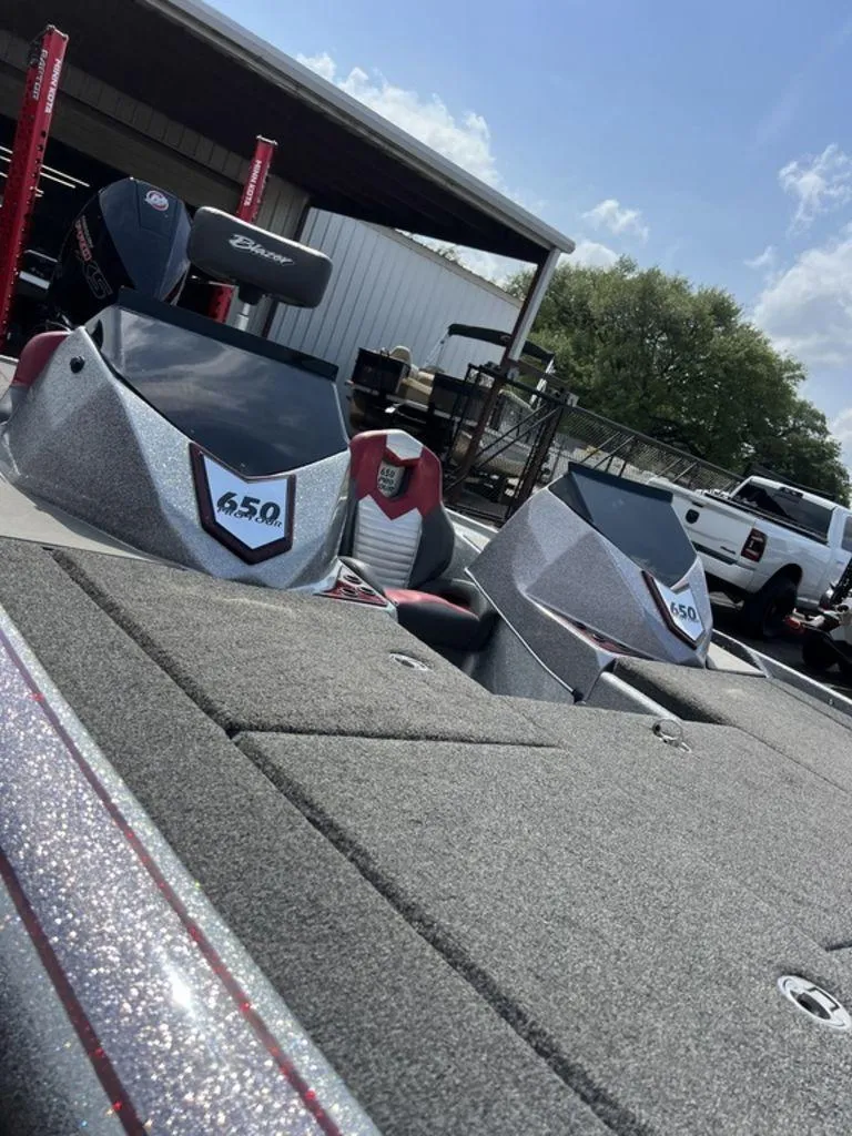 Slide: The Image of 2022 Blazer 650 Pro Tour boat with sleek design in outdoor setting. - 44