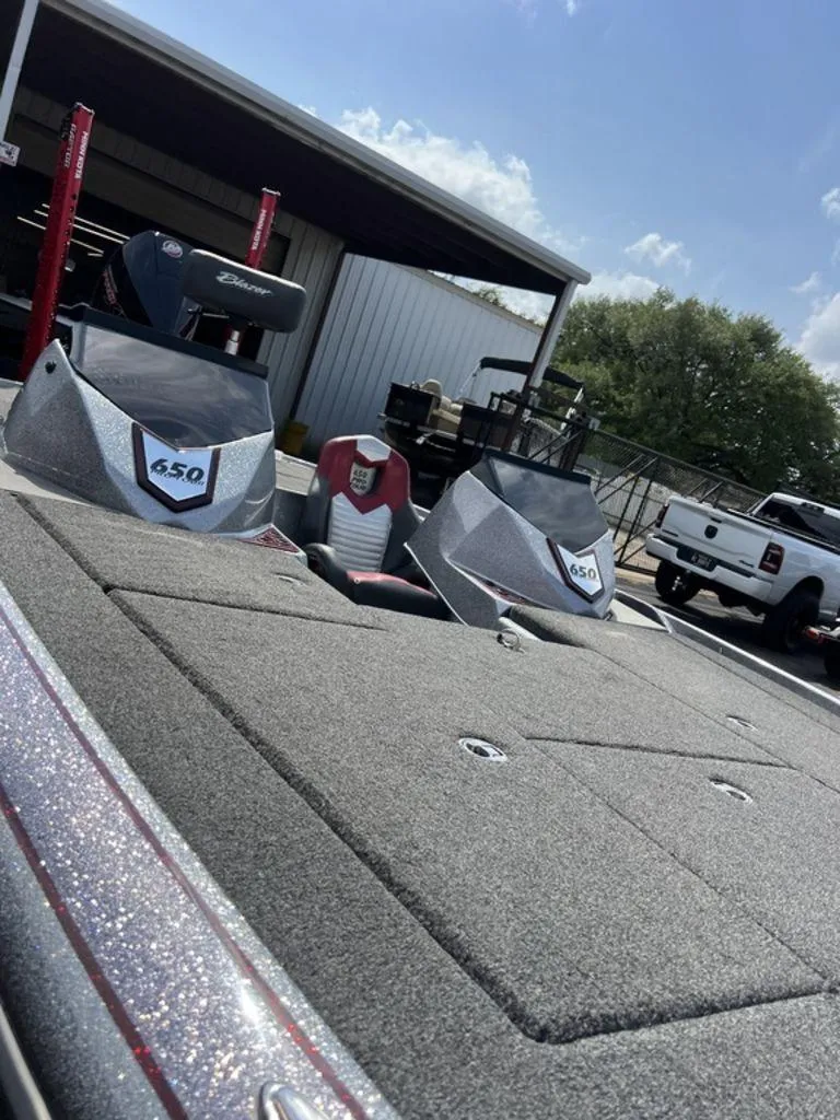Slide: The Image of 2022 Blazer 650 Pro Tour boat with dual consoles, parked outdoors. - 45