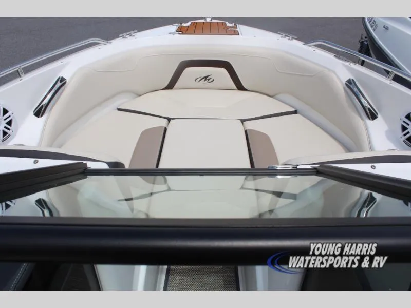 Slide: The Image of 2023 Monterey 224 FS/BR boat interior with cushioned seating and sleek design. - 11