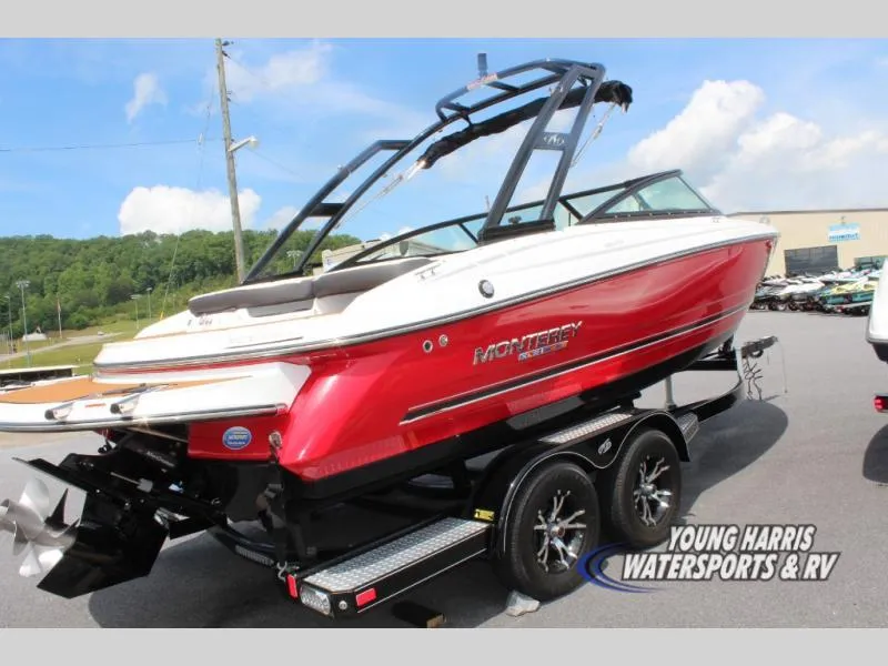 Slide: The Image of 2023 Monterey 224 FS/BR boat in vibrant red on a trailer, displayed outdoors. - 4