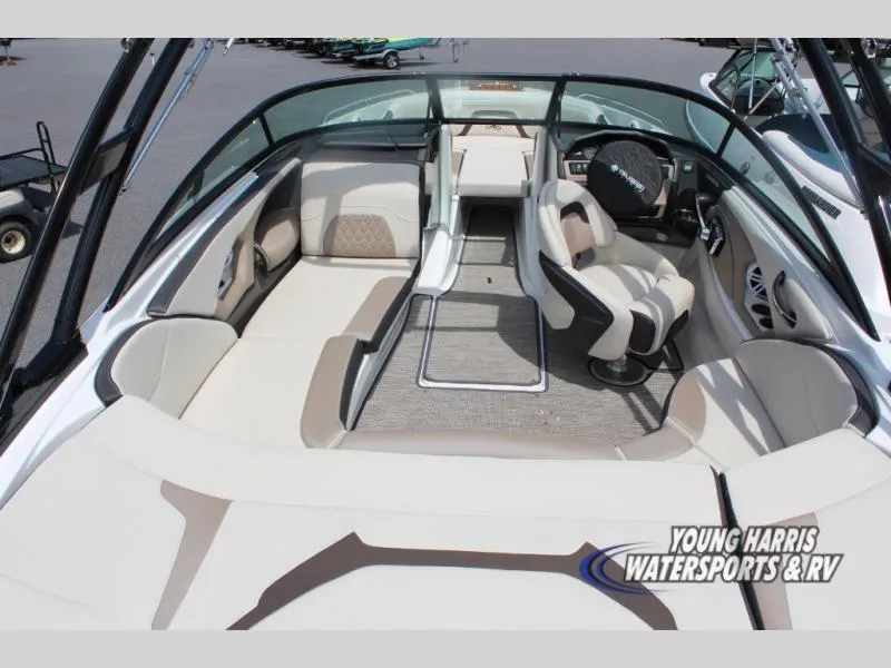 Slide: The Image of 2023 Monterey 224 FS/BR boat interior with beige seating and modern dashboard. - 5