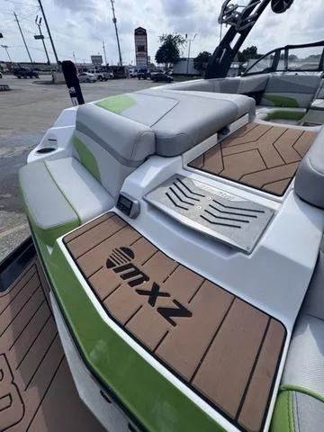 Slide: The Image of 2018 Malibu 24 MXZ boat with stylish seating and deck design. - 13