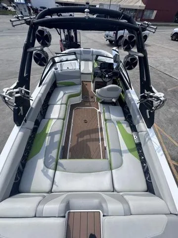 Slide: The Image of 2018 Malibu 24 MXZ boat interior with spacious seating and modern design. - 14