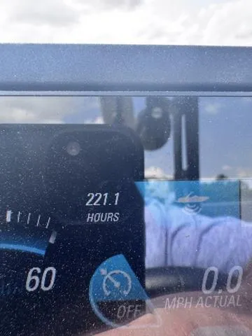 Slide: The Image of Close-up of 2018 Malibu 24 MXZ dashboard showing 221.1 hours and 0.0 MPH. - 16