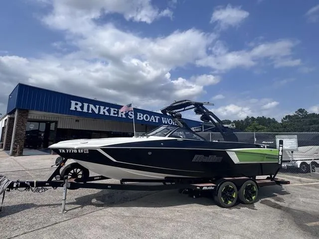 Slide: The Image of 2018 Malibu 24 MXZ boat on trailer at Rinker's Boat World dealership. - 4