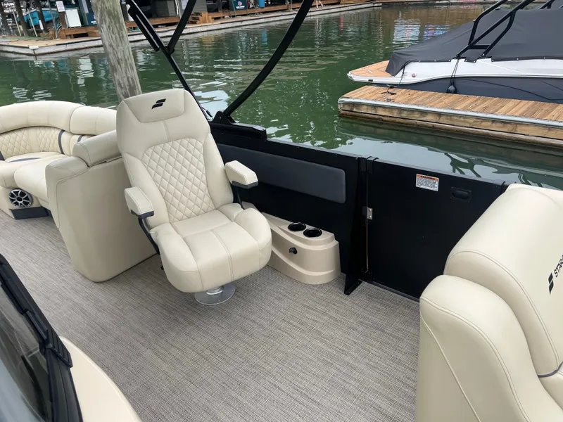 Slide: The Image of Luxurious seating on 2025 Starcraft RX 23 R DC boat at marina. - 11