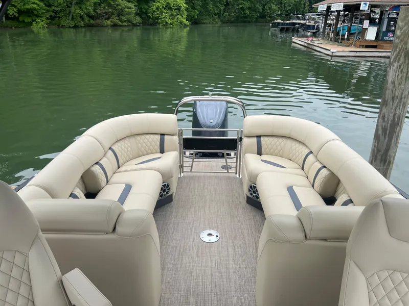 Slide: The Image of Luxurious 2025 Starcraft RX 23 R DC pontoon boat with plush seating on a serene lake. - 13