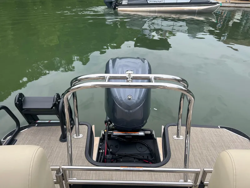 Slide: The Image of 2025 Starcraft RX 23 R DC boat with outboard motor on calm water. - 14