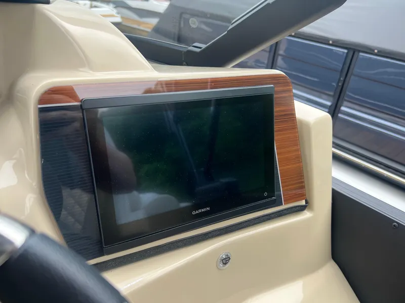Slide: The Image of 2025 Starcraft RX 23 R DC boat dashboard with Garmin display screen. - 9