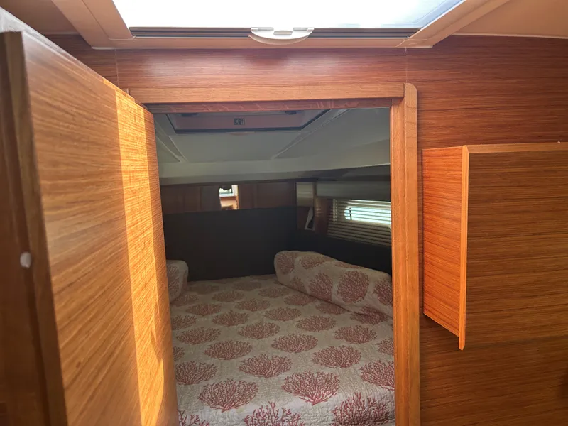 Slide: The Image of 2017 Bavaria S36 Coupe cabin with wooden interior and patterned bedding. - 17