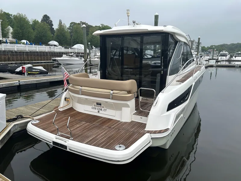 Slide: The Image of 2017 Bavaria S36 Coupe docked at a marina, showcasing sleek design and spacious deck. - 2