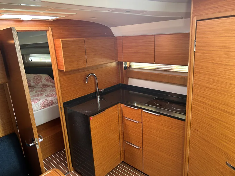 Slide: The Image of Modern kitchen interior of 2017 Bavaria S36 Coupe yacht with wood finish and compact design. - 21