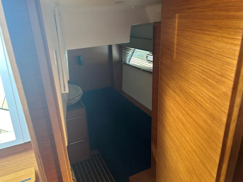 Slide: The Image of Interior cabin of 2017 Bavaria S36 Coupe with wooden finish and window blinds. - 23