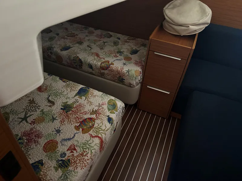 Slide: The Image of Cabin interior of 2017 Bavaria S36 Coupe with twin beds and nautical-themed bedding. - 24