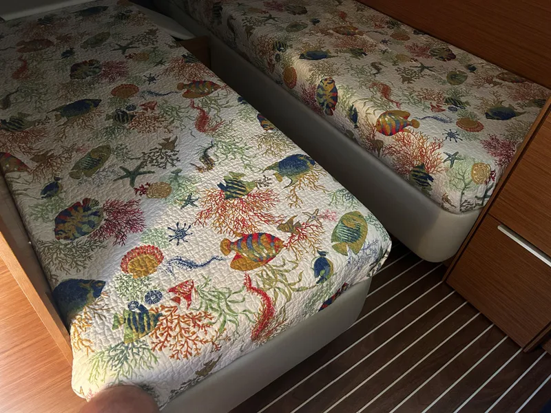 Slide: The Image of Twin beds with colorful marine-themed bedding in a 2017 Bavaria S36 Coupe. - 25