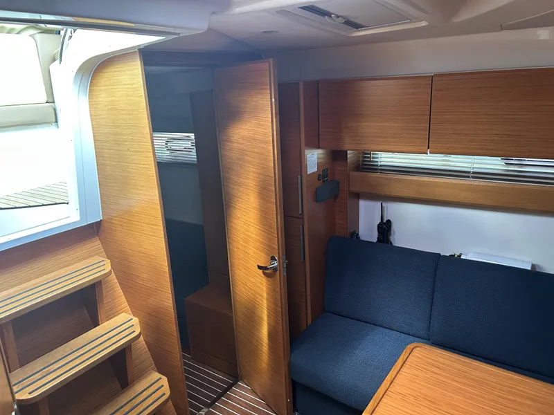 Slide: The Image of Interior of 2017 Bavaria S36 Coupe yacht with wooden finish and blue seating. - 26