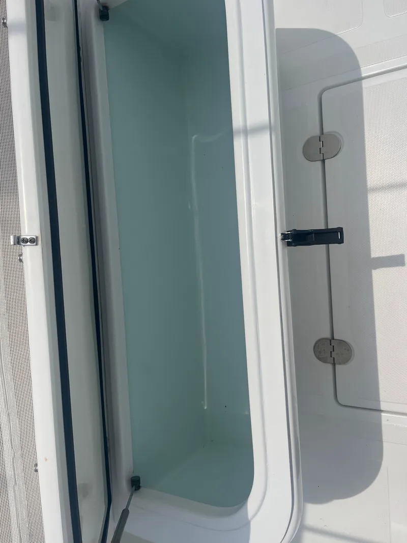 Slide: The Image of Open storage compartment on 2016 Venture 39 Forward Seating boat. - 13