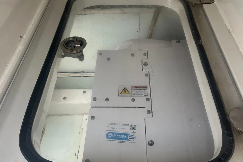 Slide: The Image of 2016 Venture 39 Forward Seating boat compartment with visible hatch and equipment. - 17