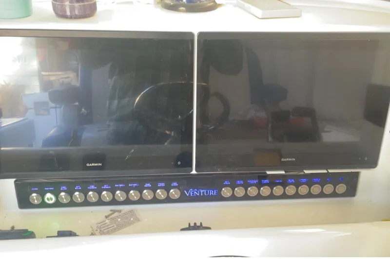 Slide: The Image of Control panel of a 2016 Venture 39 Forward Seating boat with dual Garmin screens. - 18