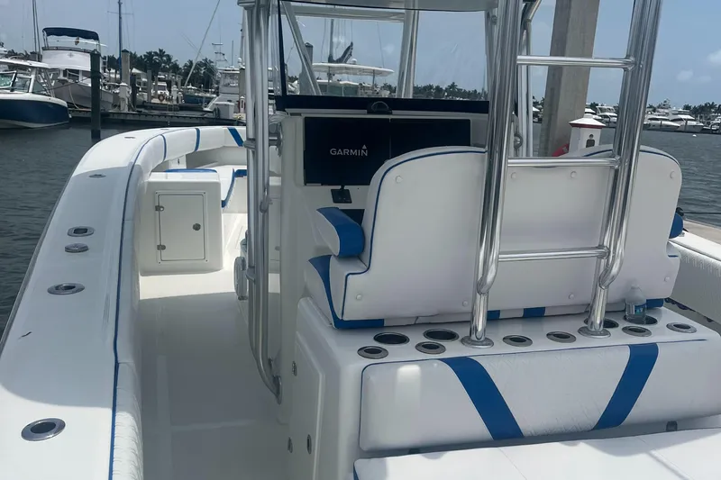 Slide: The Image of 2016 Venture 39 Forward Seating boat with blue and white interior, docked at a marina. - 5