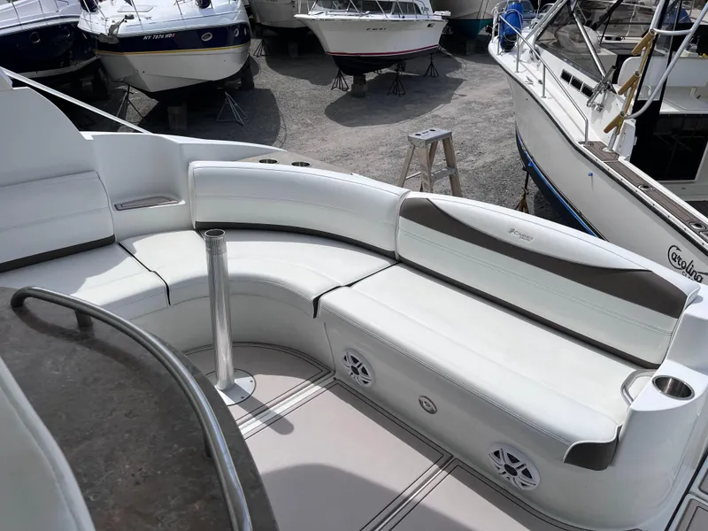 Slide: The Image of 2009 Cruisers Yachts 390 Sports Coupe with white seating in a marina setting. - 3