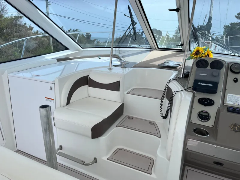 Slide: The Image of 2009 Cruisers Yachts 390 Sports Coupe helm with seating and control panel. - 4