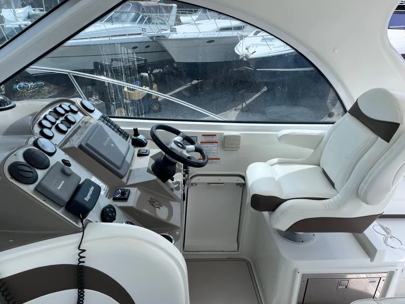 Slide: The Image of 2009 Cruisers Yachts 390 Sports Coupe helm with steering wheel and control panel. - 5