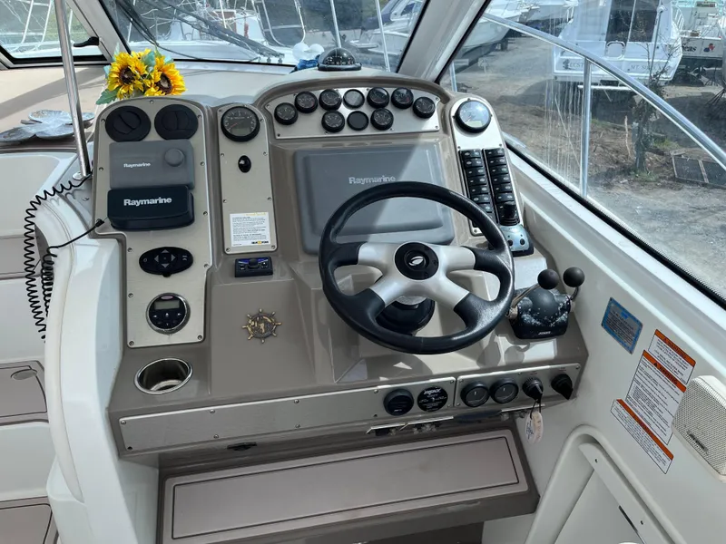 Slide: The Image of 2009 Cruisers Yachts 390 Sports Coupe helm with steering wheel and navigation controls. - 6