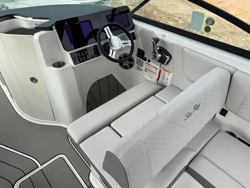 Slide: The Image of 2025 Sea Ray SDX 270 Surf boat interior with modern dashboard and steering wheel. - 9