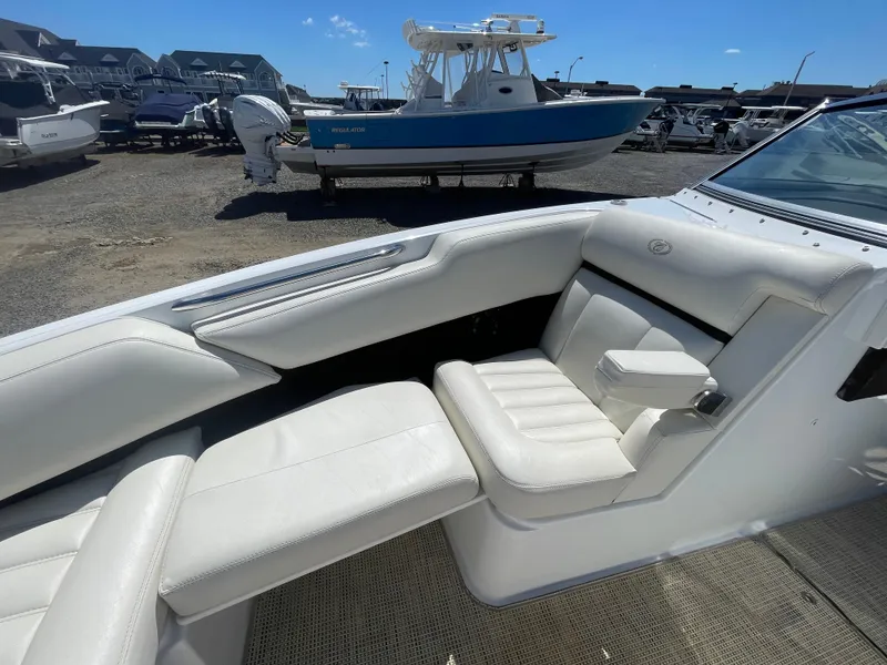Slide: The Image of 2016 Cobalt R5 boat interior with white seating, parked in a marina. - 11