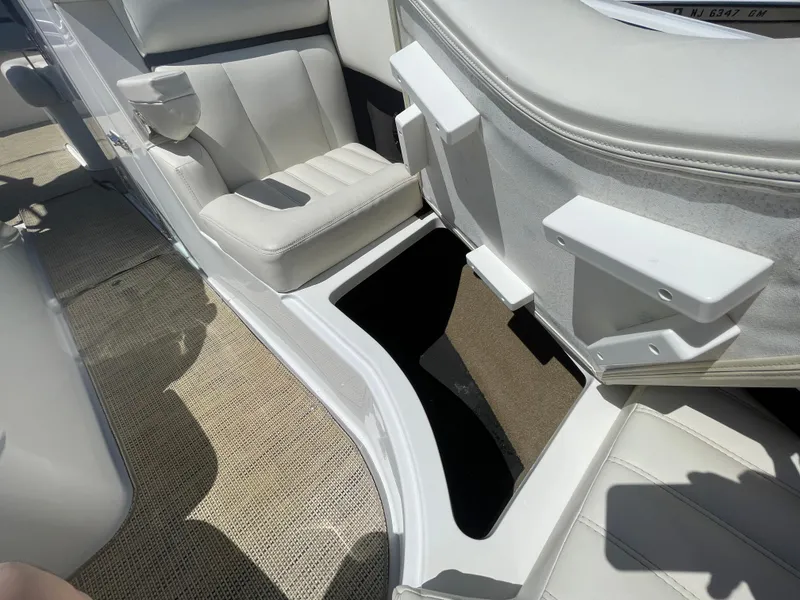 Slide: The Image of 2016 Cobalt R5 boat interior with white seating and storage compartment. - 12