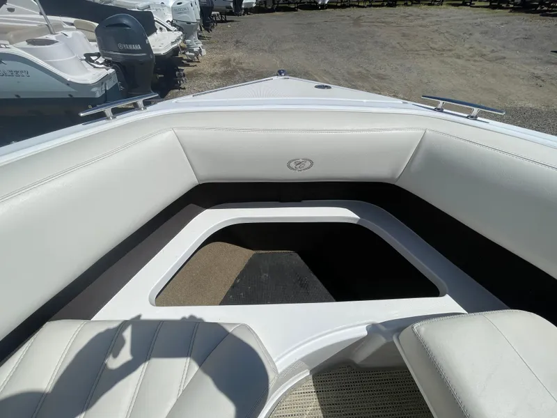 Slide: The Image of 2016 Cobalt R5 boat interior with white seating and open storage area. - 13