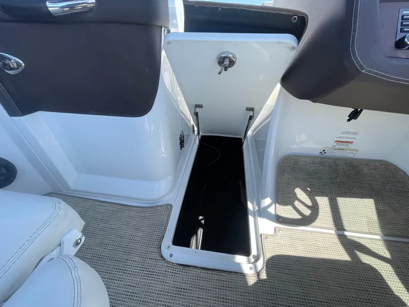 Slide: The Image of 2016 Cobalt R5 boat interior with open storage compartment, featuring white and black design. - 16