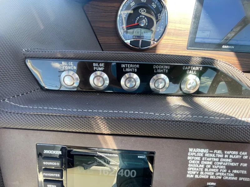 Slide: The Image of Control panel of a 2016 Cobalt R5 boat with various switches and gauges. - 21