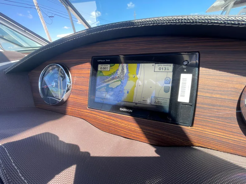 Slide: The Image of Dashboard of a 2016 Cobalt R5 boat featuring a Garmin GPS display. - 23
