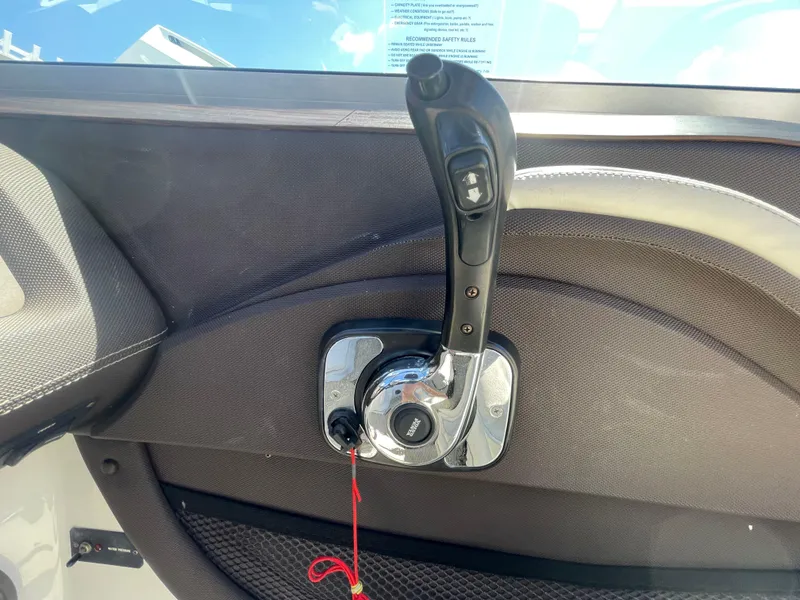 Slide: The Image of Throttle control lever on a 2016 Cobalt R5 boat dashboard. - 25